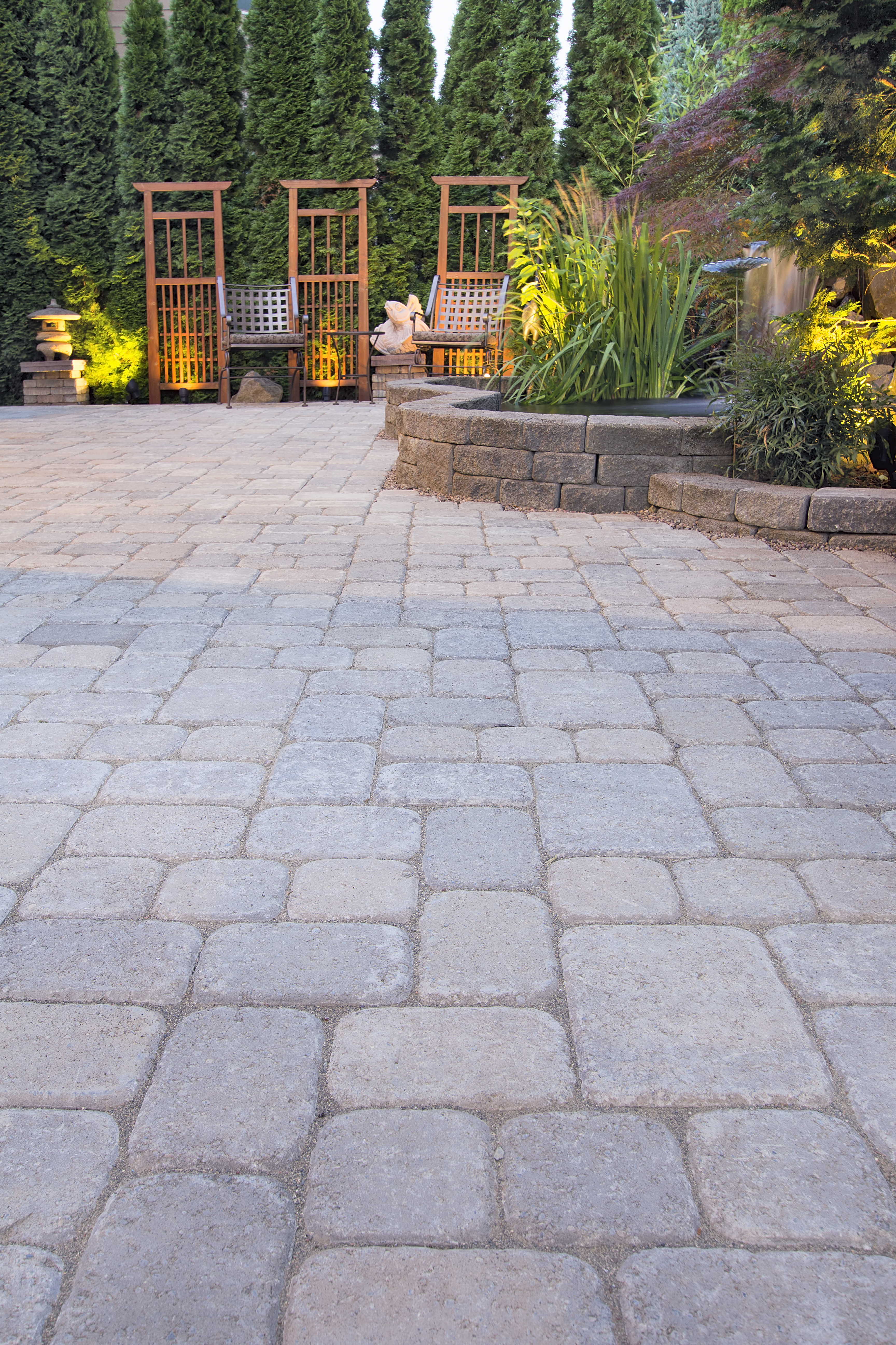 Paver Patio with Garden Decoration and Landscape Lights